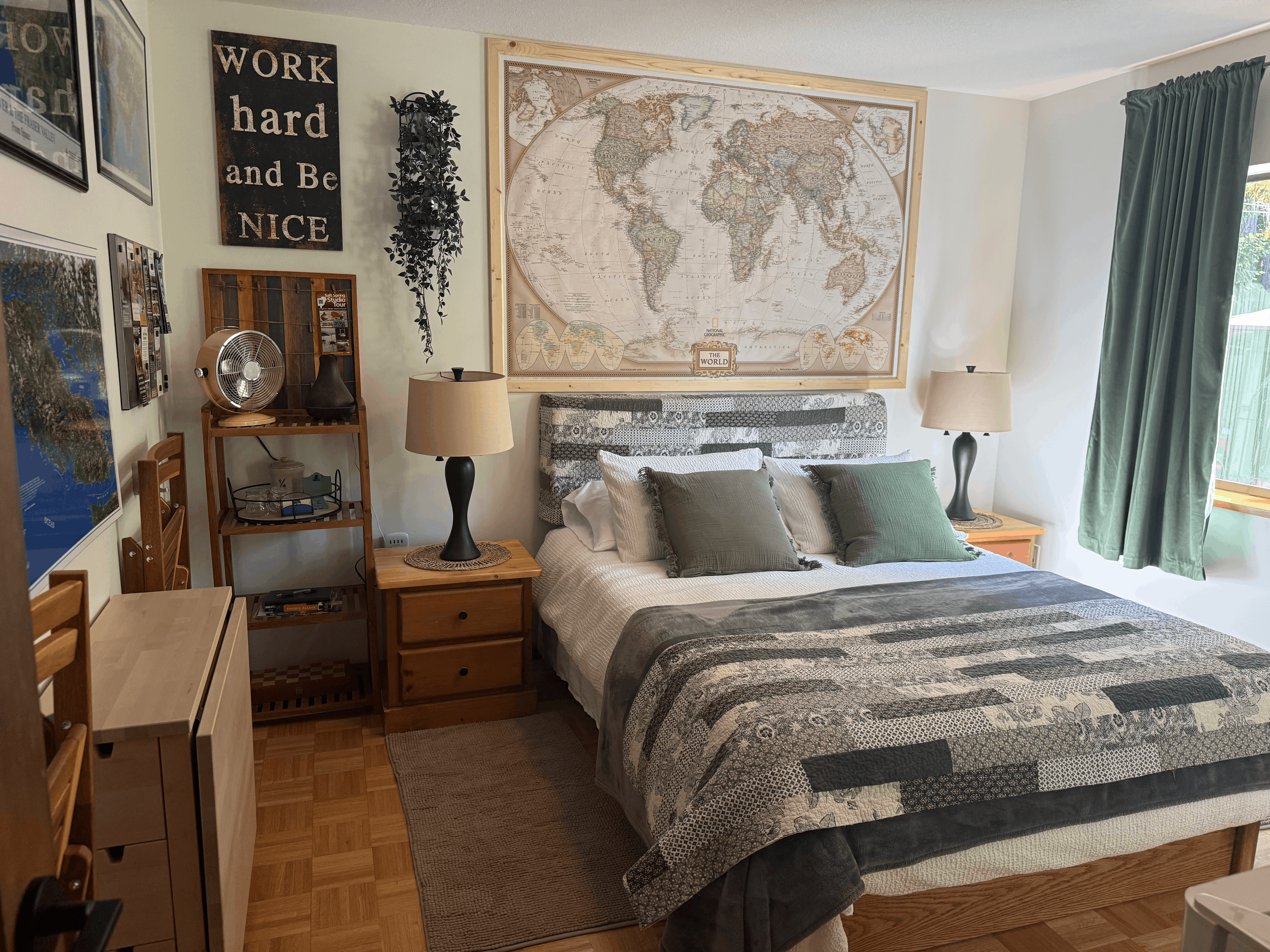 Guest bedroom with queen bed, soft lighting, and pine views