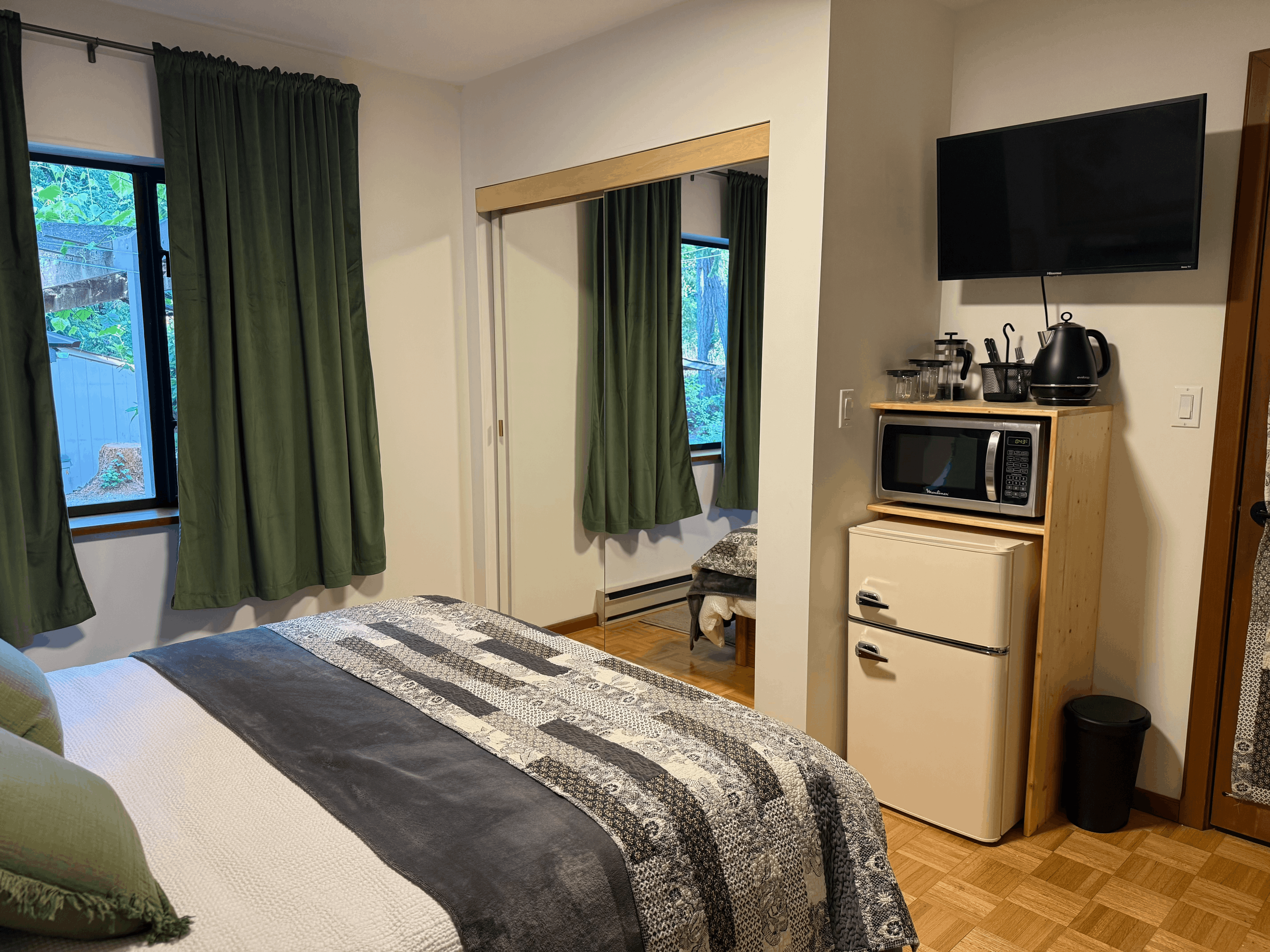 Guest room with television, microwave, and mini fridge