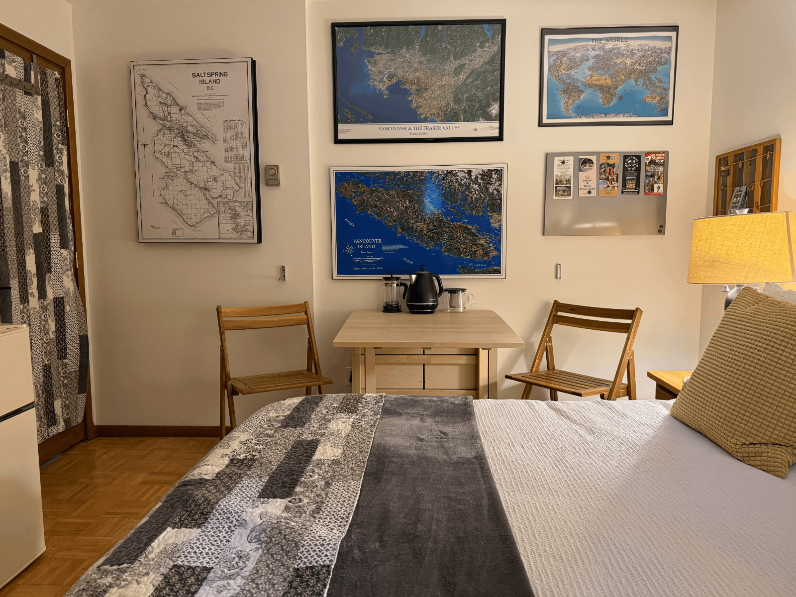 Guest room wall with maps and cozy seating